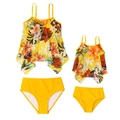 Detail of matching mother and daughter swimsuits with tropical floral print and yellow bottoms - S / Yellow Floral