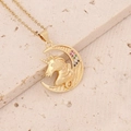 Macro shot of 18K gold unicorn and crescent moon pendant with colorful zircon stones - Moon Unicorn