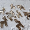 Macro detail of nine golden mirror acrylic reindeer cake toppers on a white surface - 8Pcs Christmas Deer - Gold