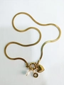 Gold snake chain necklace with embossed heart pendant and white pearl charm detail - Letter O