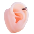 Silver titanium steel bow stud earring with red enamel detail on a model ear - Red (Single Piece)