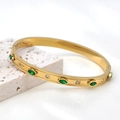Detailed macro of gold hexagram bracelet with green emeralds and small diamonds - Gold Marquise Green Zirconia