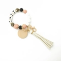 Macro detail of MAMA silicone bead keychain with leopard print and white tassel - White