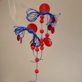 Macro shot of geometric resin disc earrings with navy braided rope and red bead accents - Red and Blue Contrast (S925 Silver Pin)