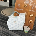 Floral canvas tote bag with cartoon bear and blue woven handles for women - Rose Bear