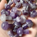 Handheld display of 2cm mini amethyst mushroom stones with natural purple textures - Amethyst