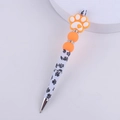 Detail of DIY beaded pen with orange dog paw silicone bead and heart pattern print - Dog Paw Orange