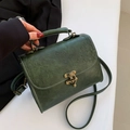 Retro dark green leather handbag with embossed floral patterns and bronze metal clasp - Green
