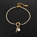Elegant 14K gold plated stainless steel bracelet featuring a rhinestone key charm - Letter I
