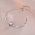 Macro detail of rotating flower bracelet with purple petals, pearls and zircon accents - Silver Purple Floral Pearl Style (TS0046)