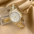 Detailed close-up of a luxury gold quartz watch with zircon-set bezel on silk fabric - Gold