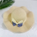 Detail of wide brim straw sun hat featuring a blue checkered bow on white fabric - M (56-58cm) with Wind Rope / Beige