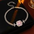 Detail of silver Cuban chain bracelet featuring a pink square zircon and star elements - Silver Pink Chain Square Style