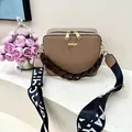 Detail of coffee brown square crossbody bag with wide patterned strap and gold hardware - Khaki