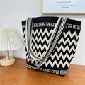 Close-up of knitted tote bag with chevron pattern on a minimalist wooden table - 20 Zigzag Pattern Black