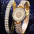 Close-up of luxury gold-tone watch set with crystals on shimmering blue background - Gold Watch And Bracelet Set (No Box)