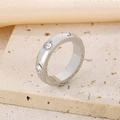 Silver stainless steel ring with round transparent stones in bezel setting - Bezel Set Style (KR111069-K)
