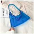 Detail of blue transparent jelly shoulder bag with plastic chain on beige blazer jacket - Blue