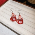 Detail shot of acrylic gingerbread man in red glitter cup Christmas earrings on a white tray - Christmas Red Glitter Cup Gingerbread Man Style