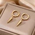 Macro detail of gold-plated cone hoop earrings displayed on premium jewelry packaging - Cone Pendant Style / Gold Cone