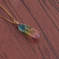 Macro view of rainbow crystal hexagonal pendant wrapped in intricate gold wire - A-NSN0234 Gold Copper Box Chain