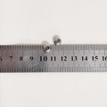 Macro shot of 10mm polished stainless steel DIY bracelet connector beads on a metric scale - Positioning Bead / 8x4x2.7mm / Steel