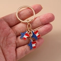 Macro shot of metal keychain with US flag enamel star charm and bell accessories - Red Blue Pentagram