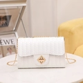 White crossbody bag with V-shaped weave pattern and golden diamond rotary lock closure - White