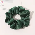 Macro shot of dark green silk satin scrunchie with elegant folds and glossy texture - Dark Green