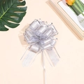 Silver pull bow ribbon for gift wrapping with metallic grid texture on pink backdrop - Silver