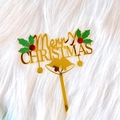 Close-up of golden acrylic Merry Christmas cake topper with red berries and green leaves - Christmas Leaf Bell Merry Christmas