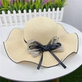 Detail of woven straw hat featuring a black and white wavy edge with elegant double bow - M (56-58cm) with Windproof Rope / Beige