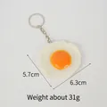 Realistic PVC fried egg keychain with a metal ring, measuring 5.7cm by 6.3cm - Poached Egg - Keychain
