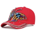 Detail of red cotton baseball cap featuring sparkling rhinestone butterfly and silver studs - Adjustable / Red