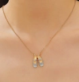 Elegant gold ballet slippers pendant necklace with sparkling crystals on a female model - Gold (Light Blue/White Toe)