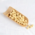 High-quality shelled hazelnut kernels displayed in a traditional bamboo scoop - Hazelnuts (500g)