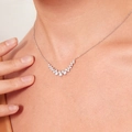 Elegant silver V-shaped necklace with shimmering zircons worn by a female model - Silver-White Zirconia