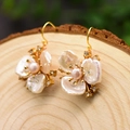 Handcrafted gold flower earrings with pink natural pearls on a rustic wood background - Three-Petal Flower Dangle (MOP/Pink Pearl/Zircon)