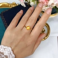 Deep golden freshwater pearl ring with gold-tone bypass band on a model's finger - 7-8mm (Adjustable) / Gold