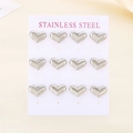Macro shot of twelve silver heart-shaped stainless steel stud earrings on a display stand - 6 Pairs/Card / Steel Color Style (KE116837-HR)