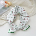 White cotton linen scarf with red floral print and green border tied in a knot - Small Flower Green