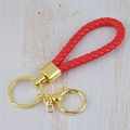 Red braided leather keychain with golden metal ring and spring clasp on wood background - Generation 1 Round Dragon Woven Buckle (Light Gold) / Red