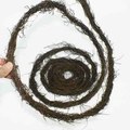 Close-up of natural dark brown plant vine coil showing textured dried vegetable fiber - Hama Vine