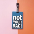 Blue rectangular PVC luggage tag with bold white 'not YOUR BAG!' embossed text - not YOUR BAG Slogan / Blue