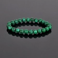 Natural 8mm malachite beaded bracelet with green striped stones on reflective background - Malachite