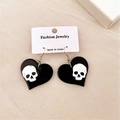 Detalle de pendientes de corazón gótico con patrón de calavera blanca en tejido - Calavera de Corazón