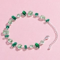 Detail view of silver bracelet with green cubic zirconia in various geometric cuts - Green Zircon - White Gold