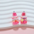 Detailed view of mini pink floating bottles with stars, flowers and liquid for DIY charms - Rose Pink Wish Bottle