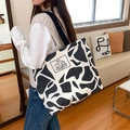 Cow print canvas tote bag with black strap and cartoon bear graphic print - Encounter Bear-Beige