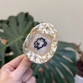 Macro view of retro virtual pet style acetate hair claw with pixel art and heart cutouts - 7cm / Beige